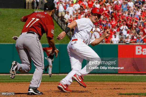 Ryan Ludwick of the St. Louis Cardinals is caught in a rundown against Pedro Feliz of the Houston Astros in the home opener at Busch Stadium on April...