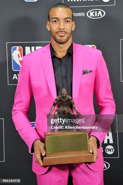 Rudy Gobert, winner of the Defensive Player of the Year award, poses in the backstage photo room during the 2018 NBA Awards Show at Barker Hangar on...