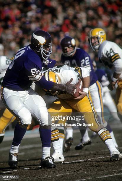 S: Defensive Tackle Alan Page of the Minnesota Vikings stops running back Donny Anderson of the Green Bay Packers circa early 1970's during an NFL...