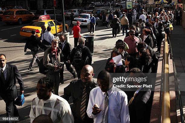 Hundreds of people looking for employment wait in line to attend an AARP job fair with an emphasis on individuals 50 years old and over on April 12,...