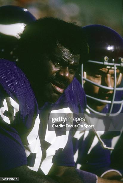 Defensive Tackle Alan Page of the Minnesota Vikings in this portrait sitting on the bench circa mid 1970's during an NFL football game at...