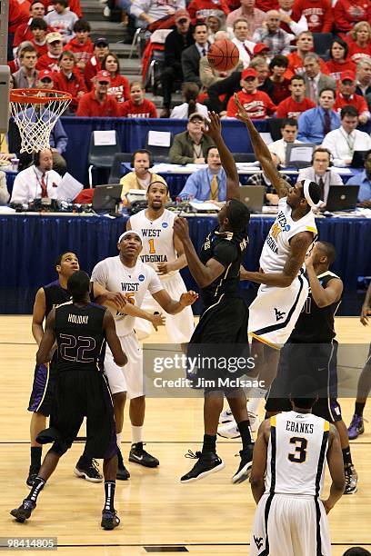 John Flowers of the West Virginia Mountaineers attempts a shot against the Washington Huskies during the east regional semifinal of the 2010 NCAA...