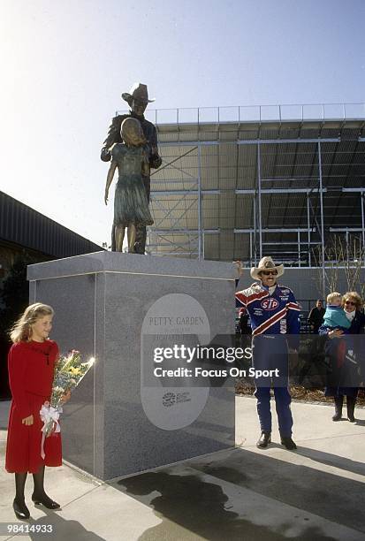 Nascar driver Richard Petty in this portrait with a statue in honor of him for 35 years of accomplishments and dedication to stock car racing,...
