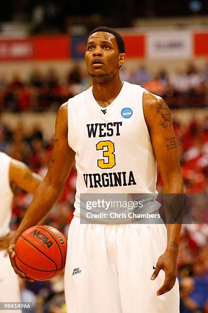 Devin Ebanks the West Virginia Mountaineers gets set to shoot a free throw attempt against the Washington Huskies during the east regional semifinal...
