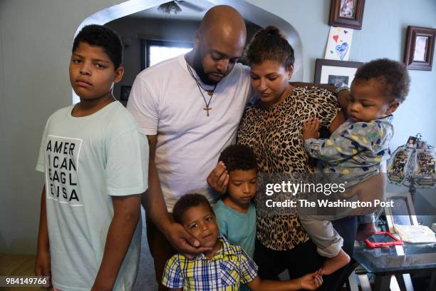 Michael and Ashley Cannon stand with their children, left to right, Pierce 12, Niles Clark and 17-month-old Beaux in their home on June 24, 2018 in...