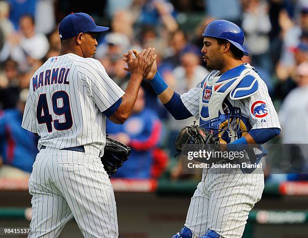 Carlos Marmol of the Chicago Cubs shakes hands with catcher Geovany Soto after a win over the Milwaukee Brewers on Opening Day at Wrigley Field on...