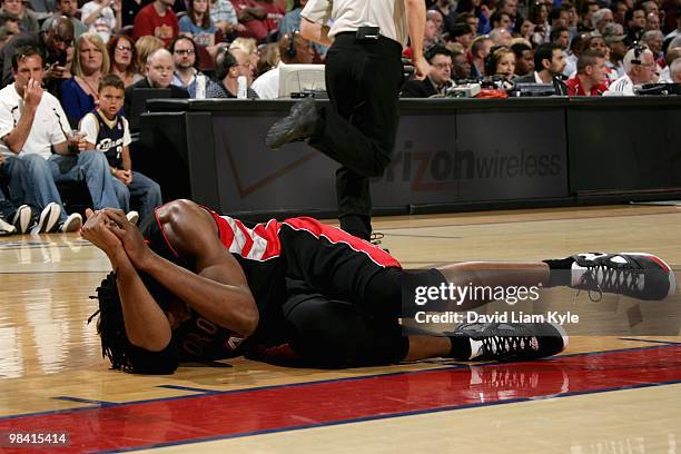 Chris Bosh of the Toronto Raptors lays on the court after getting hit in the face during the game against the Cleveland Cavaliers on April 6, 2010 at...