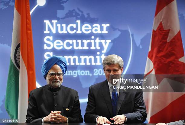 Indian Prime Minister Manmohan Singh and Canadian Prime Minister Stephen Harper take their seats at the start of their bilateral meeting on the...
