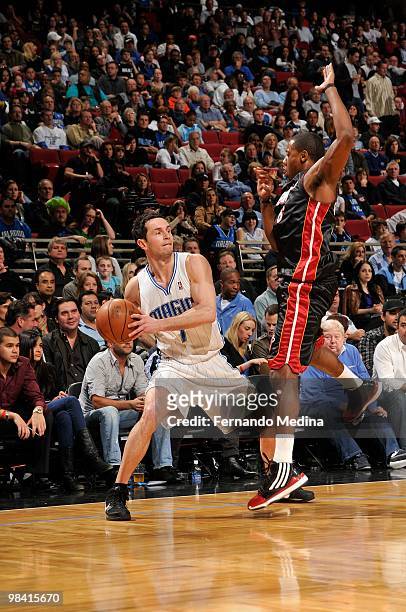 Redick of the Orlando Magic moves the ball against Mario Chalmers of the Miami Heat during the game on February 28, 2010 at Amway Arena in Orlando,...