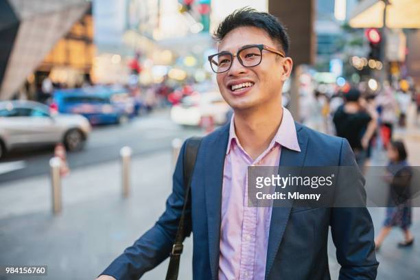 businessman walking in the streets of kuala lumpur - chinese male confident stock pictures, royalty-free photos & images