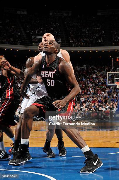 Joel Anthony of the Miami Heat rebounds against Marcin Gortat of the Orlando Magic during the game on February 28, 2010 at Amway Arena in Orlando,...