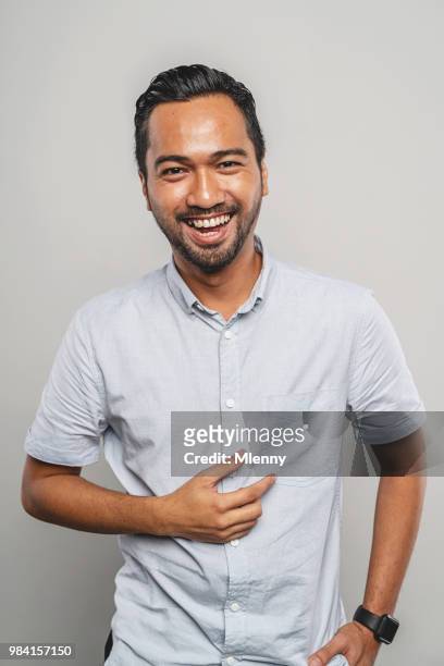 laughing malaysian man portrait - handsome muslim men stock pictures, royalty-free photos & images