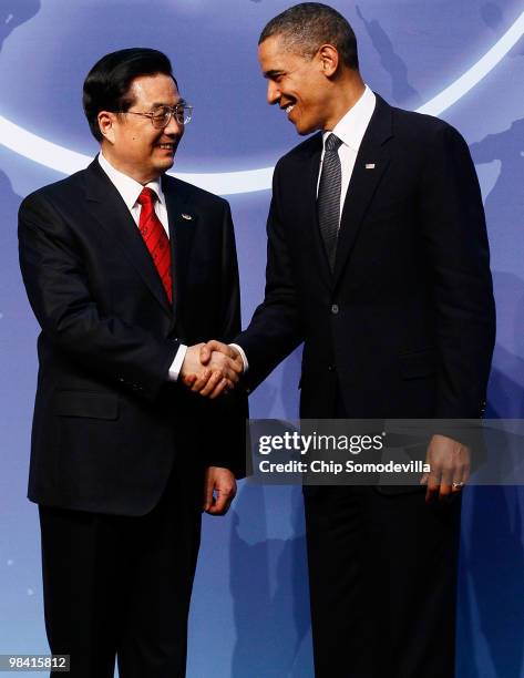 President Barack Obama and Chinese President Hu Jintao pose for photographs at the start of the Nuclear Security Summit at the Washington Convention...