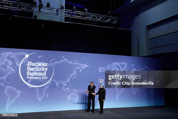 President Barack Obama welcomes Indian President Manmohan Singh at the start of the Nuclear Security Summit at the Washington Convention Center April...