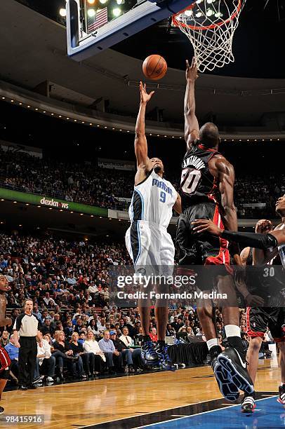 Rashard Lewis of the Orlando Magic lays up a shot against Joel Anthony of the Miami Heat during the game on February 28, 2010 at Amway Arena in...