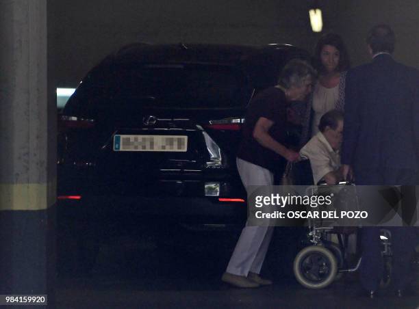 Man, believed to be Spanish former doctor Eduardo Vela is pushed on a wheelchair as he arrives at a provincial court in Madrid, on June 26, 2018 to...