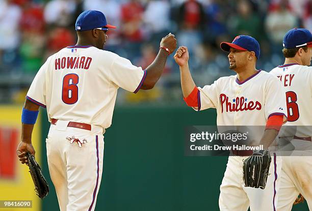 Ryan Howard and Shane Victorino of the Philadelphia Phillies congratulate each other after beating the Washington Nationals 7-4 on Opening Day at...