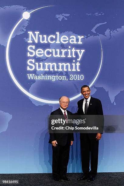 President Barack Obama poses for photographs with the Director General of the International Atomic Energy Agency Yukiya Amano at the start of the...