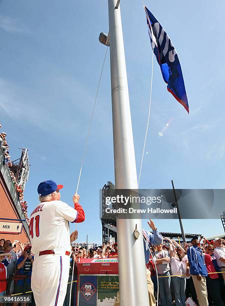 Manager Charlie Manuel of the Philadelphia Phillies raises the National League Champion flag before the game against the Washington Nationals on...