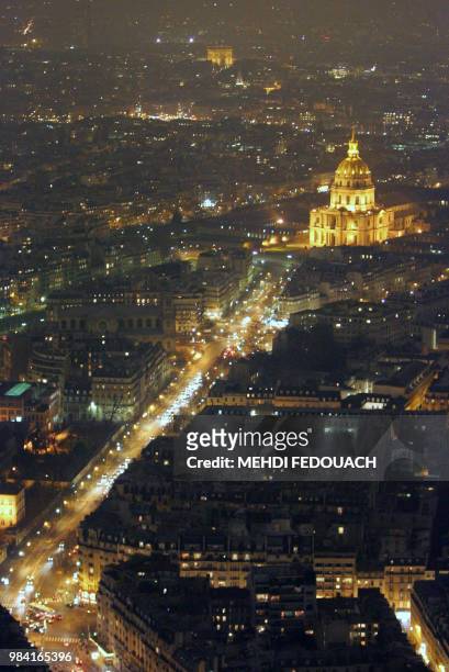 The Invalides stands in lightness as the Eiffel Tower stands in darkness after its spotlights were switched off for 5 minutes under a global scheme...