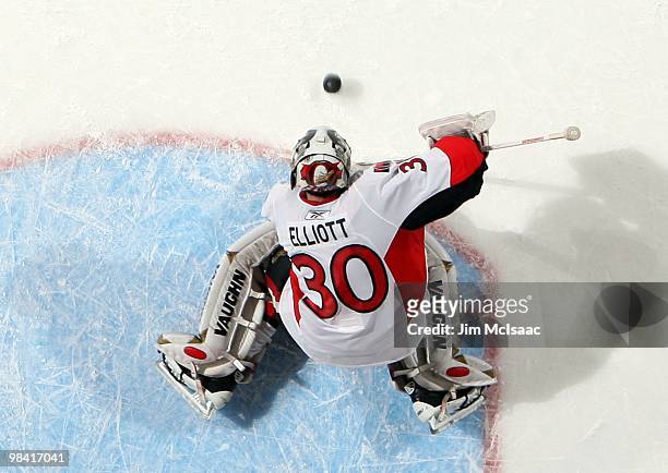 Brian Elliott of the Ottawa Senators defends against the New York Islanders on April 3, 2010 at Nassau Coliseum in Uniondale, New York. The Isles...
