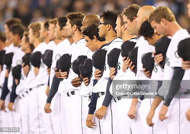 Members of the Seattle Mariners observe a moment of silence to remember officers Tina Griswold, Ronald Owens, Greg Richards, Sgt. Mark Renninger,...