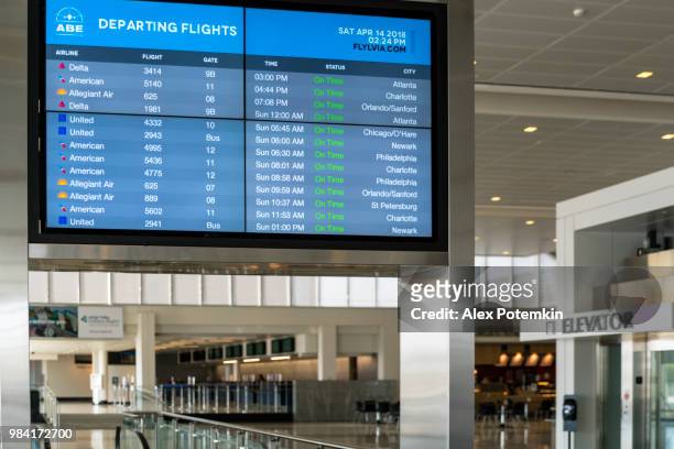 all on time! informational tableau with flights schedule in the airport lounge - alex potemkin or krakozawr stock pictures, royalty-free photos & images