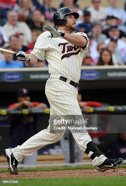 Jason Kubel of the Minnesota Twins hits a solo homerun in the seventh inning against the Boston Red Sox during the Twins home opener at Target Field...
