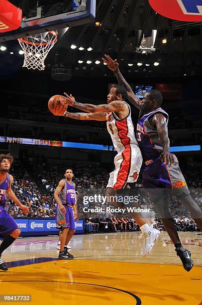 Monta Ellis of the Golden State Warriors shoots a layup against Jason Richardson of the Phoenix Suns during the game at Oracle Arena on March 22,...