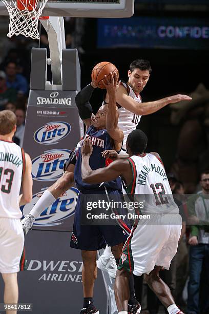 Maurice Evans of the Atlanta Hawks shoots a layup against Carlos Delfino and Luc Richad Mbah a Moute of the Milwaukee Bucks on April 12, 2010 at the...