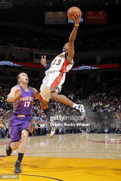 Watson of the Golden State Warriors shoots a layup against Louis Amundson of the Phoenix Suns during the game at Oracle Arena on March 22, 2010 in...