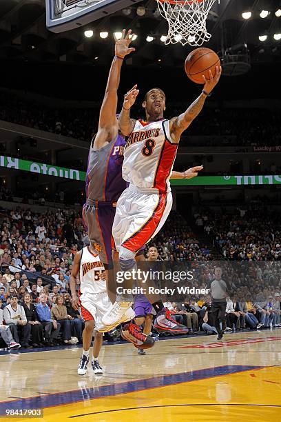 Monta Ellis of the Golden State Warriors shoots a layup against Jared Dudley of the Phoenix Suns during the game at Oracle Arena on March 22, 2010 in...