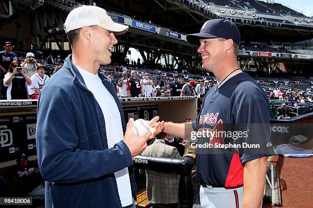 San Diego Chargers quarterback Philip Rivers greets Chipper Jones of the Atlanta Braves before the San Diego Padres home opener on April 12, 2010 at...