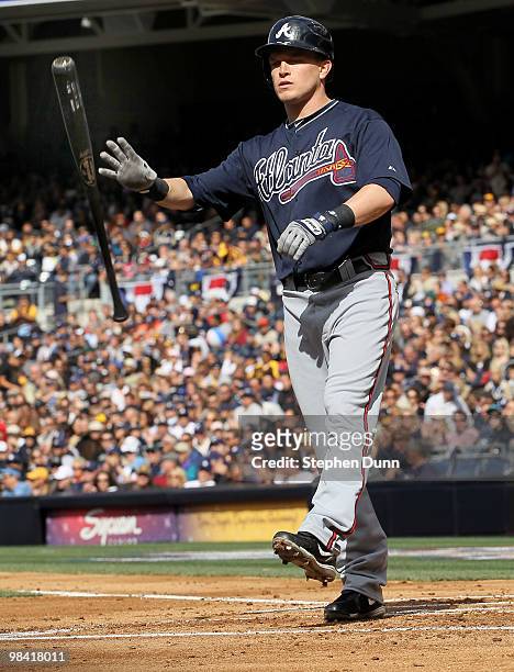 Nate McLouth of the Atlanta Braves flips his bat after striking out for the third out of the second inning with two runners on base against the San...