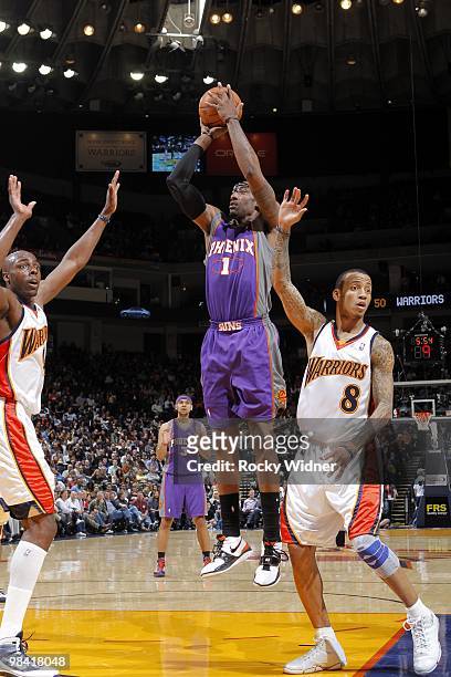 Amar'e Stoudemire of the Phoenix Suns shoots a jumper against Anthony Tolliver and Monta Ellis of the Golden State Warriors during the game at Oracle...