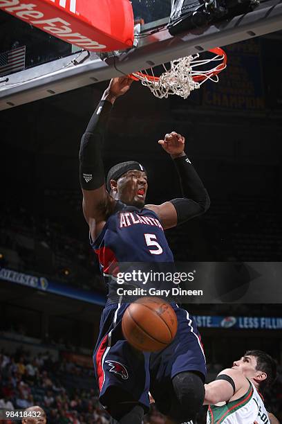 Josh Smith of the Atlanta Hawks dunks against Ersan Ilyasova of the Milwaukee Bucks on April 12, 2010 at the Bradley Center in Milwaukee, Wisconsin....