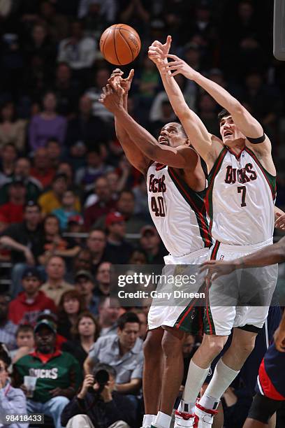 Kurt Thomas and Ersan Ilyasova of the Milwaukee Bucks reach for a rebound against the Atlanta Hawks on April 12, 2010 at the Bradley Center in...