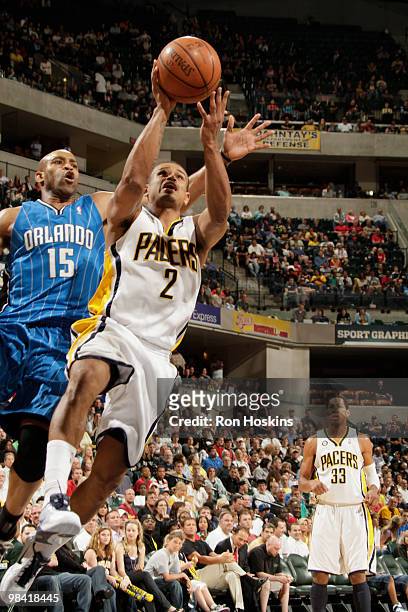 Earl Watson of the Indiana Pacers lays the ball up over Vince Carter of the Orlando Magic at Conseco Fieldhouse on April 12, 2010 in Indianapolis,...