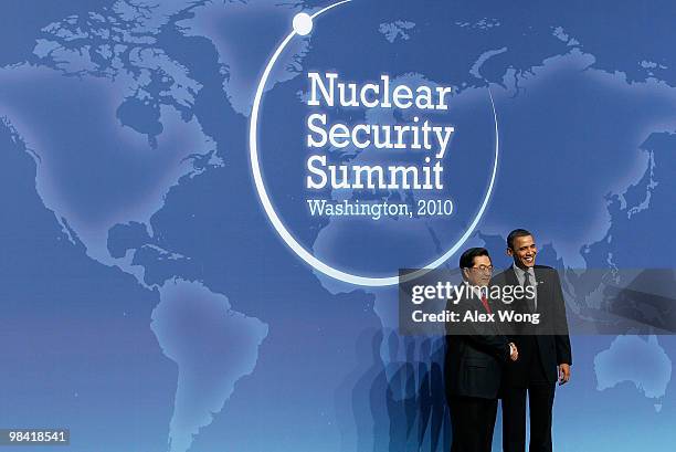 President Barack Obama poses for photographers with President of China Hu Jintao at the Nuclear Security Summit April 12, 2010 in Washington, DC....