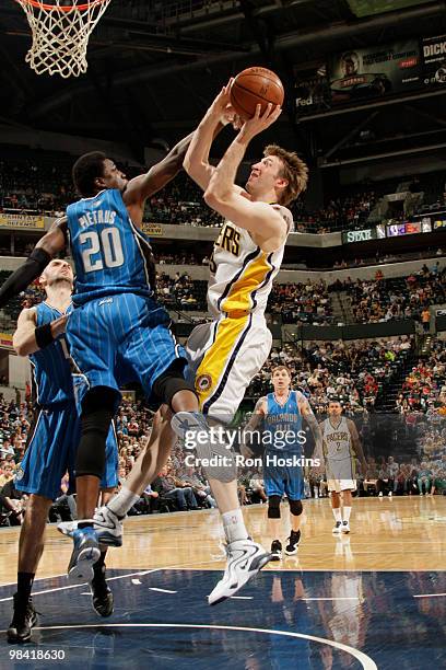 Troy Murphy of the Indiana Pacers shoots over Meckael Pietrus of the Orlando Magic at Conseco Fieldhouse on April 12, 2010 in Indianapolis, Indiana....