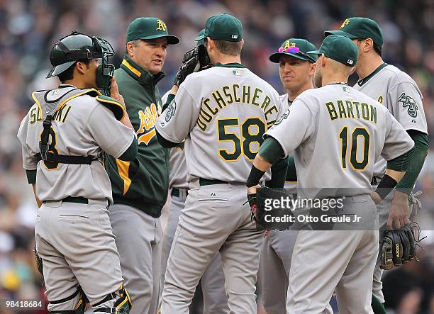 Manager Bob Geren of the Oakland Athletics talks with starting pitcher Justin Duchscherer during the home opener game against the Seattle Mariners...