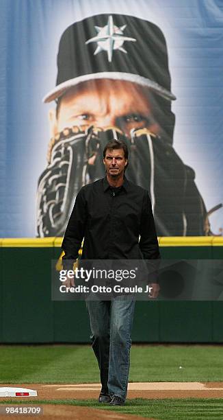Former Mariners star Randy Johnson walks on to the field to throw out the ceremonial first pitch prior to the Mariners' home opener against the...