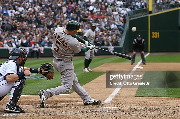 Kevin Kouzmanoff of the Oakland Athletics hits a sac fly against the Seattle Mariners during the Mariners' home opener at Safeco Field on April 12,...