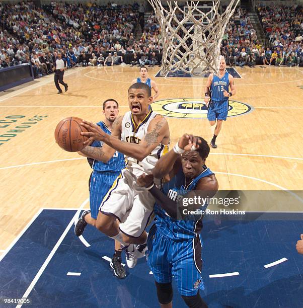 Earl Watson of the Indiana Pacers battles Mickael Pietrus of the Orlando Magic at Conseco Fieldhouse on April 12, 2010 in Indianapolis, Indiana. NOTE...