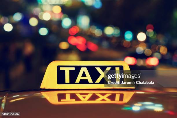 night taxi - taxi sign stock pictures, royalty-free photos & images