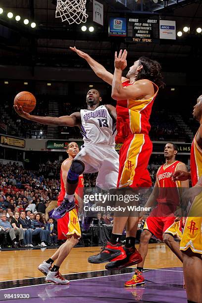 Tyreke Evans of the Sacramento Kings takes the ball to the basket against Luis Scola of the Houston Rockets on April 12, 2010 at ARCO Arena in...