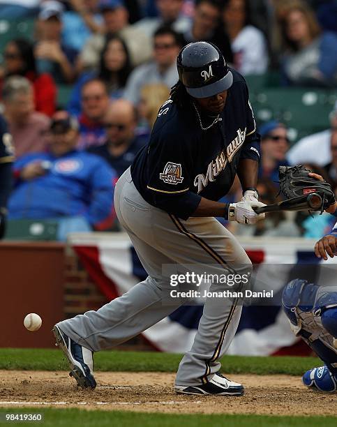 Rickeie Weeks of the Milwaukee Brewers recoils after being hit by a pitch in the 9th inning against the Chicago Cubs on Opening Day at Wrigley Field...