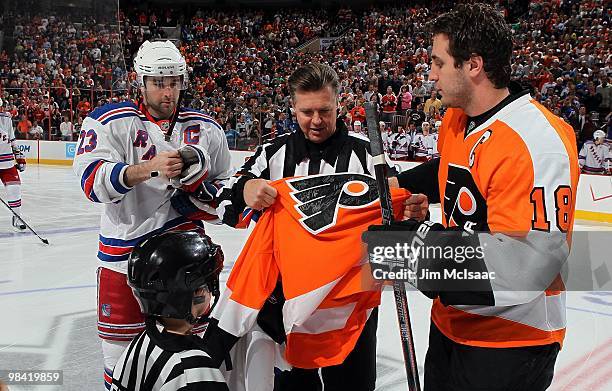Referee Kerry Fraser is presented team jerseys from Chris Drury of the New York Rangers and Mike Richards of the Philadelphia Flyers prior to the...