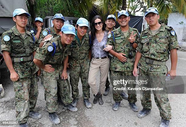 Actress Demi Moore poses with a group of Japanese UN soldiers during a visit to a camp for internally displaced persons managed by actor Sean Penn...