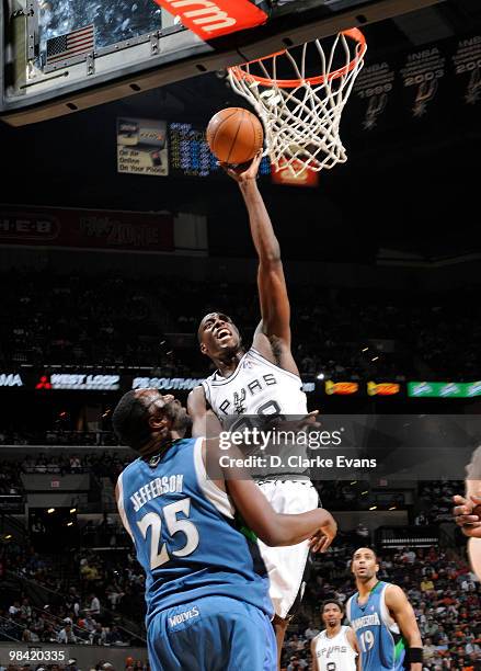 Ian Mahinmi of the San Antonio Spurs shoots against Al Jefferson of the Minnesota Timberwolves on April 12, 2010 at the AT&T Center in San Antonio,...